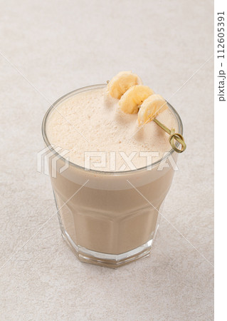 Glass of raf coffee with dried banana 112605391