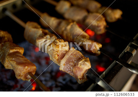 Summer Barbecue at Home Featuring Kebabs Grilling in a Backyard Grill Summer Barbecue at Home Featuring Kebabs Grilling in a Backyard Grill 112606533
