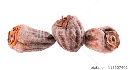 Dried persimmon isolated on white background. Dried fruit snack. Dried persimmon isolated on white background. Dried fruit snack. 112607401
