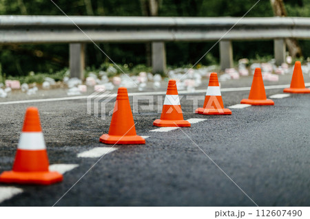 six orange traffic cones standing in row on mountain road six orange traffic cones standing in row on mountain road 112607490