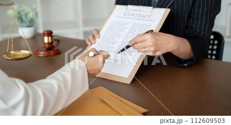 Lawyer office the company hired the lawyer office a legal advisor and draft the contract so that the client could signs contract. Contract of sale was on the table in the lawyer office Lawyer office the company hired the lawyer office a legal advisor and draft the contract so that the client could signs contract. Contract of sale was on the table in the lawyer office 112609503