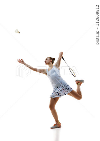 Concentrate young woman, badminton athlete in motion playing isolated over white background. Winning game Concentrate young woman, badminton athlete in motion playing isolated over white background. Winning game 112609812