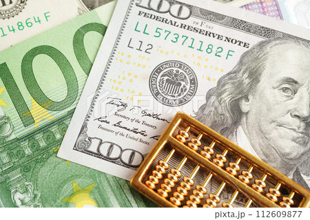 Gold abacus on banknote money, finance trading investment business currency concept. Gold abacus on banknote money, finance trading investment business currency concept. 112609877