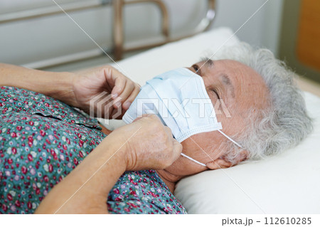 Asian elderly woman patient wearing a mask for protect Covid-19 Coronavirus. Asian elderly woman patient wearing a mask for protect Covid-19 Coronavirus. 112610285