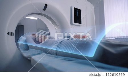 Woman undergoes MRI or CT scan diagnostic. VFX animation of scanning Woman undergoes MRI or CT scan diagnostic. VFX animation of scanning 112610869