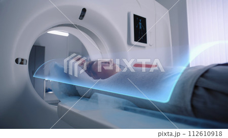 Woman undergoes MRI or CT scan diagnostic. VFX animation of scanning Woman undergoes MRI or CT scan diagnostic. VFX animation of scanning 112610918