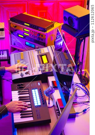 male music producer hands working on professional audio equipment in recording studio. music production concept male music producer hands working on professional audio equipment in recording studio. music production concept 112612065