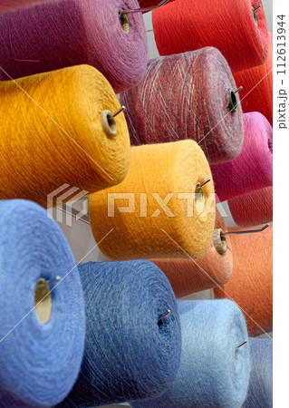 Assorted spools of multi-colored wool threads Assorted spools of multi-colored wool threads 112613944