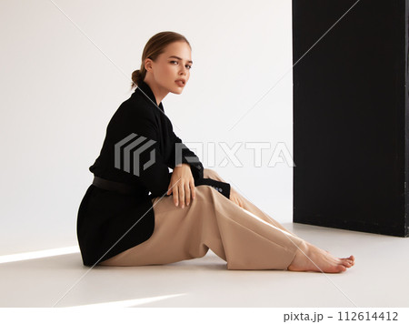 Fashionable confident woman wearing elegant white Fashionable confident woman wearing elegant white 112614412