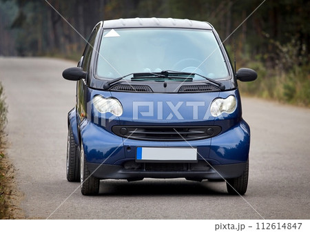 Little blue car driving on the road, modern city car background Little blue car driving on the road, modern city car background 112614847