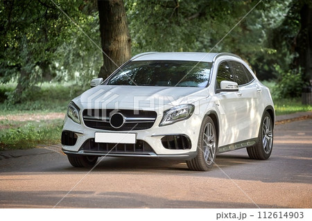 Modern white car driving in the country side background, luxury city car wallpaper Modern white car driving in the country side background, luxury city car wallpaper 112614903