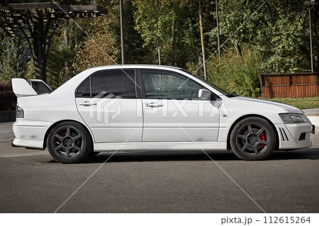 White car on a street background. Modern city sport car with a spoiler wallpaper 112615264