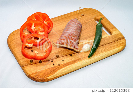 Tasty sausages and vegetables isolated over solid background 112615398