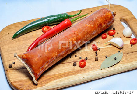 Tasty sausages and vegetables isolated over solid background Tasty sausages and vegetables isolated over solid background 112615417