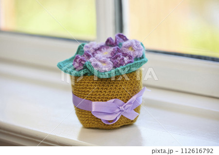 Knitted toys violet on the windowsill 112616792