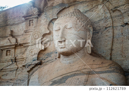 Beautiful face of Buddha at Gal Vihara. This is an unusual feature in ancient Sinhalese sculpture in ancient city of Polonnaruwa. Beautiful face of Buddha at Gal Vihara. This is an unusual feature in ancient Sinhalese sculpture in ancient city of Polonnaruwa. 112621789