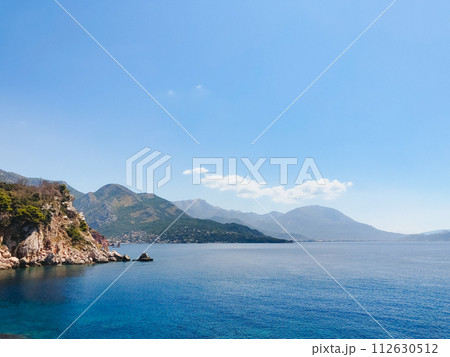 Top view Montenegro Sutomore stones beach blue turquoise Adriatic sea water mountains day Top view Montenegro Sutomore stones beach blue turquoise Adriatic sea water mountains day 112630512