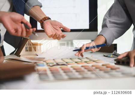 Cropped shot of designers choosing color swatches for interior renovation at office table 112630608