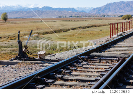manual railroad switch with lever and counterweight at summer day 112633686