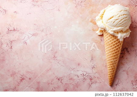 Classic Vanilla Ice Cream Cone on a Soft Pink Marble Background 112637042