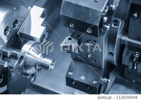 The  CNC lathe machine forming  cutting the metal shaft parts. 112638848