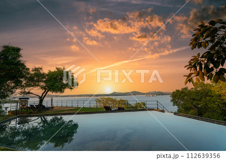 The tranquil infinity pool at Kandalama Heritage Hotel in Sri Lanka at dusk. 112639356