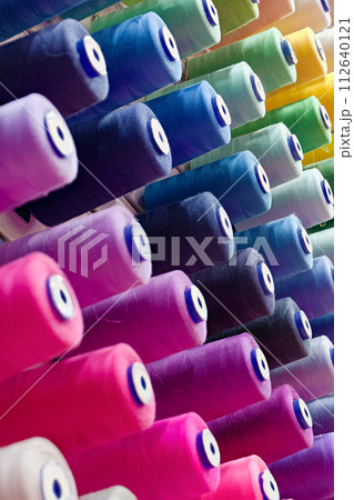 Assorted spools of multi-coloured cotton threads 112640121