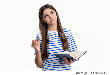 thoughtful teen girl writing school diary in studio. teen girl writing school diary book. thoughtful teen girl writing school diary in studio. teen girl writing school diary book. 112640715