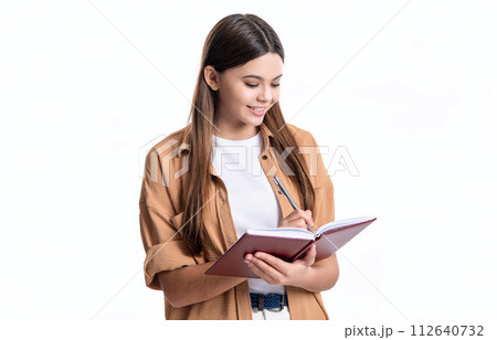 photo of cheerful teen girl noting school diary. teen girl noting school diary isolated on white 112640732
