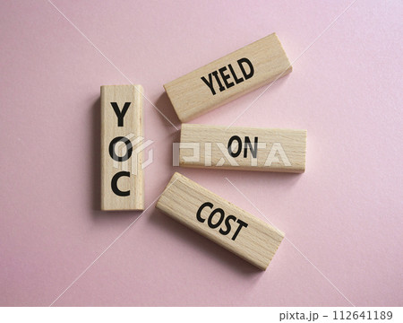 YOC - Yield on Cost. Wooden cubes with word YOC. Beautiful pink background. Business and YOC concept. Copy space. YOC - Yield on Cost. Wooden cubes with word YOC. Beautiful pink background. Business and YOC concept. Copy space. 112641189