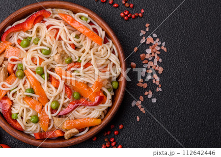Delicious rice noodles or udon with chicken, carrots, pepper, salt, spices and herbs Delicious rice noodles or udon with chicken, carrots, pepper, salt, spices and herbs 112642446