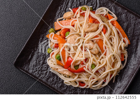 Delicious rice noodles or udon with chicken, carrots, pepper, salt, spices and herbs Delicious rice noodles or udon with chicken, carrots, pepper, salt, spices and herbs 112642555