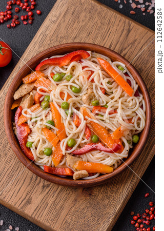 Delicious rice noodles or udon with chicken, carrots, pepper, salt, spices and herbs Delicious rice noodles or udon with chicken, carrots, pepper, salt, spices and herbs 112642584
