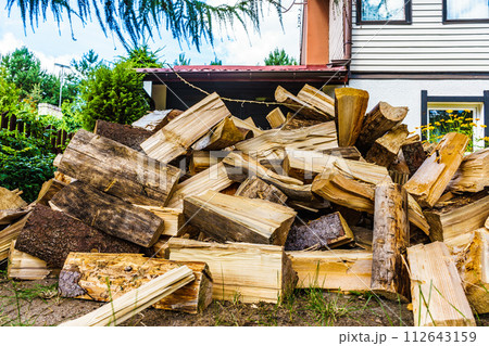 Stack of firewood at house 112643159