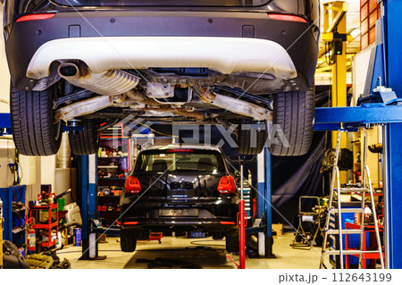 Car lifted in automobile service 112643199