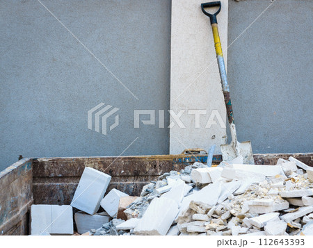 Spade in pile of rubble. Spade in pile of rubble. 112643393