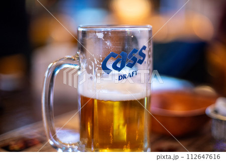 A glass of fresh Korean Cass draft beer served in a bar in Seoul, Korea A glass of fresh Korean Cass draft beer served in a bar in Seoul, Korea 112647616