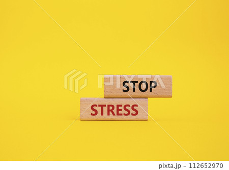 Stop Stress symbol. Concept word Stop Stress on wooden blocks. Beautiful yellow background. Business and Stop Stress concept. Copy space 112652970