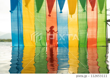 Colorful fabric in Inle, Myanmar. Clothes material for design decoration background. Handcraft Colorful fabric in Inle, Myanmar. Clothes material for design decoration background. Handcraft 112653111