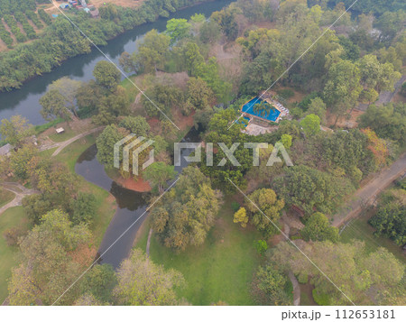 Aerial top view of lush green trees from above in tropical forest in national park in summer season. Natural landscape. Pattern texture background. Aerial top view of lush green trees from above in tropical forest in national park in summer season. Natural landscape. Pattern texture background. 112653181