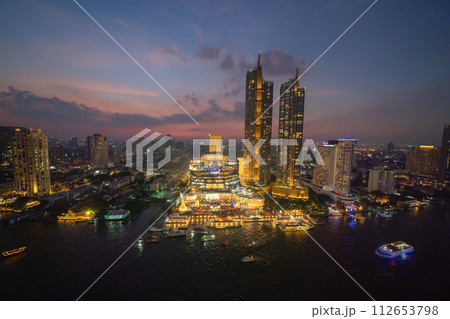 Aerial view of boats and Taksin Bridge with Chao Phraya River, Bangkok Downtown. Thailand. Financial district and business centers in smart urban city. Skyscraper and high-rise buildings. 112653798