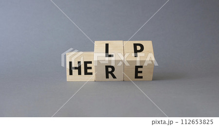 Help is here symbol. Turned wooden cubes with words Here to Help. Beautiful grey background. Business and Help is here concept. Copy space 112653825