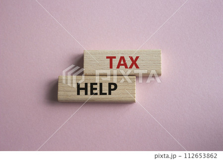 Tax Help symbol. Concept word Tax Help on wooden blocks. Beautiful pink background. Business and Tax Help concept. Copy space 112653862