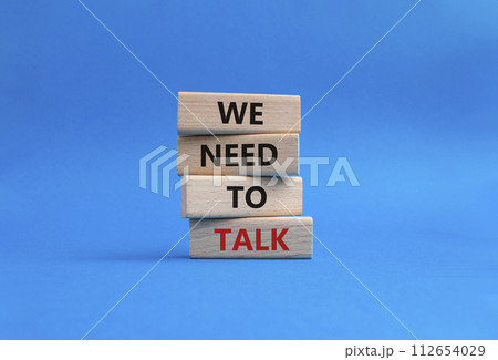 We need to talk symbol. Concept words We need to talk on wooden blocks. Beautiful blue background. Business and We need to talk concept. Copy space. 112654029