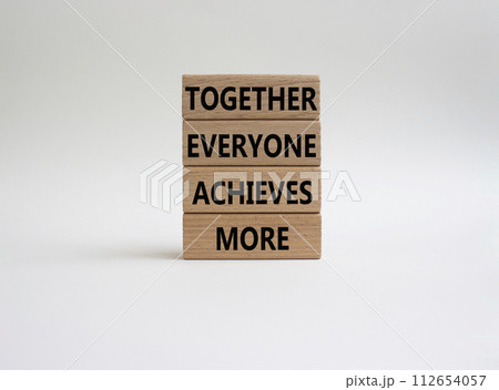 Together Everyone Achieves More symbol. Concept words Together Everyone Achieves More on wooden blocks. Beautiful white background. Business concept. Copy space. 112654057