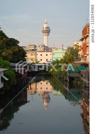 Samut Prakan Observation Tower with river reflection in urban city town, Thailand. 112654068