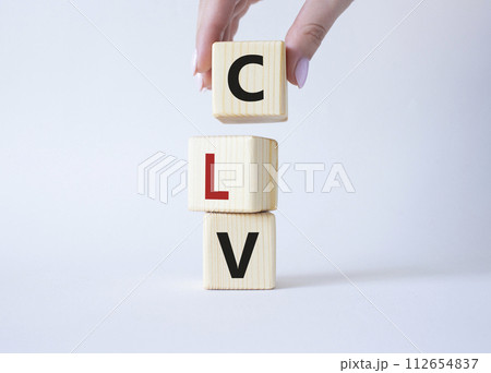 CLV - Customer Lifetime Value symbol. Concept word CLV on wooden cubes. Businessman hand. Beautiful white background. Business and CLV concept. Copy space. 112654837