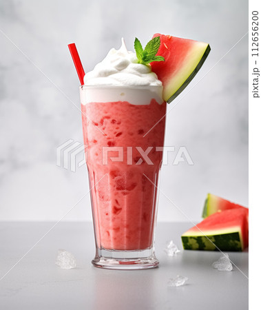 Watermelon milkshake cocktail in tall glass on concrete surface, beautifully decorated slice watermelon, whipped cream and straw Watermelon milkshake cocktail in tall glass on concrete surface, beautifully decorated slice watermelon, whipped cream and straw 112656200