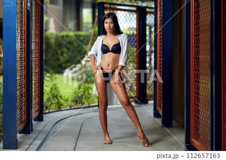 Young asian sexy girl in a white bikini posing at hotel territory Young asian sexy girl in a white bikini posing at hotel territory 112657163