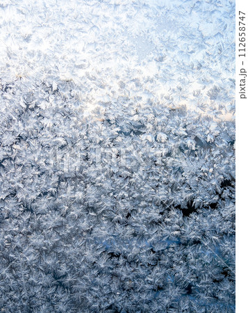 frost on home window glass close up on winter dusk 112658747